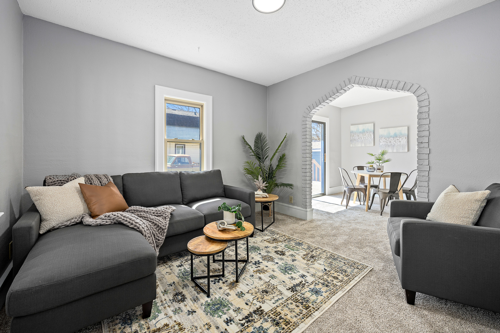 Two-story house with beige siding and covered porch at 830 W 7th St, Sioux Falls, SD during early evening