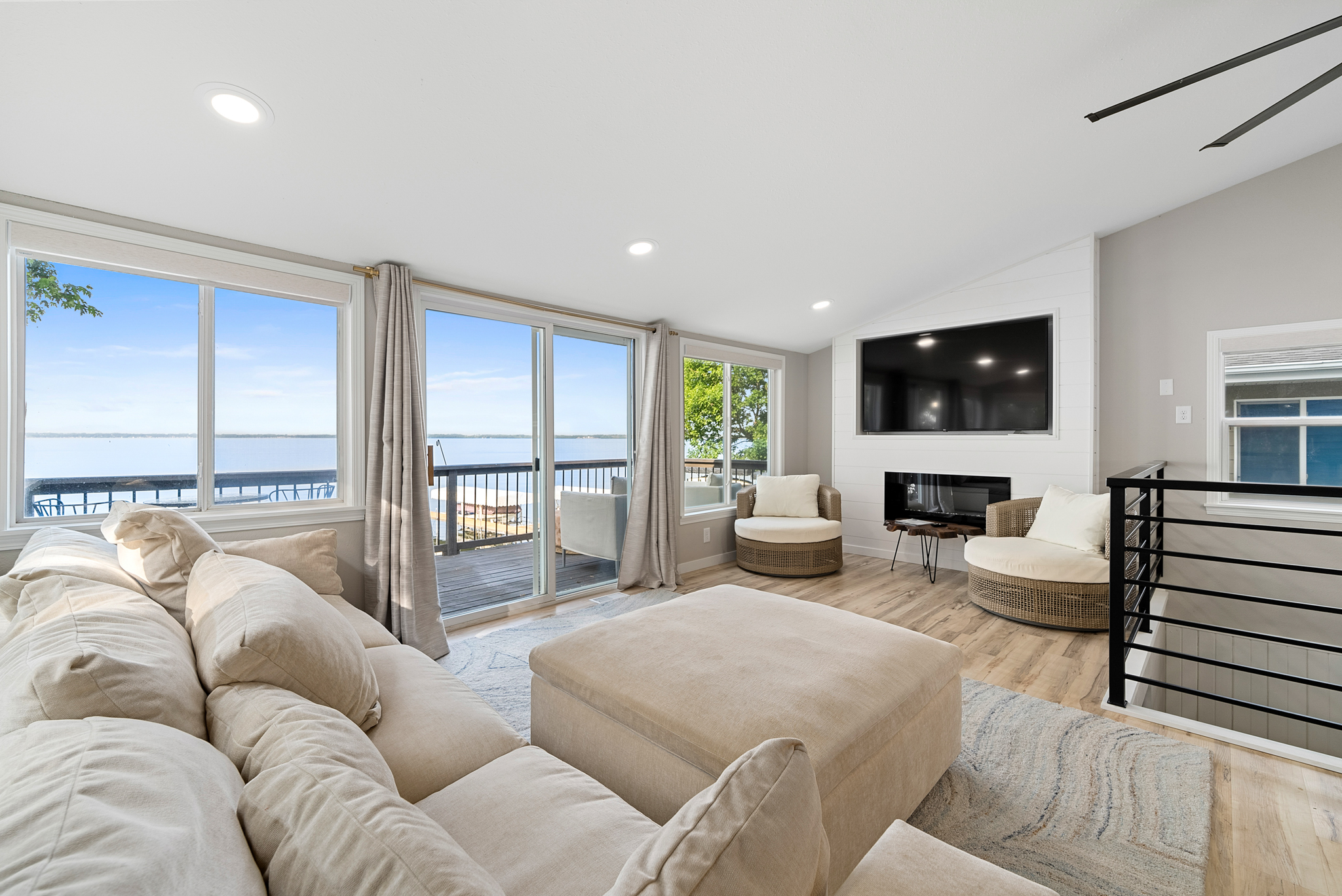 Two-story home with gray siding and fenced backyard at dusk in Sioux Falls, SD